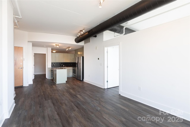 kitchen featuring baseboards, dark wood-style flooring, stainless steel refrigerator with ice dispenser, open floor plan, and backsplash