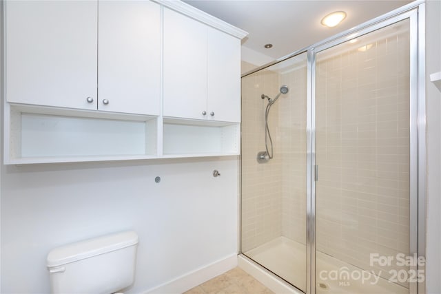 full bathroom featuring a stall shower and toilet