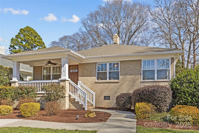 view of front of house featuring ceiling fan, a chimney, crawl space, a porch, and brick siding