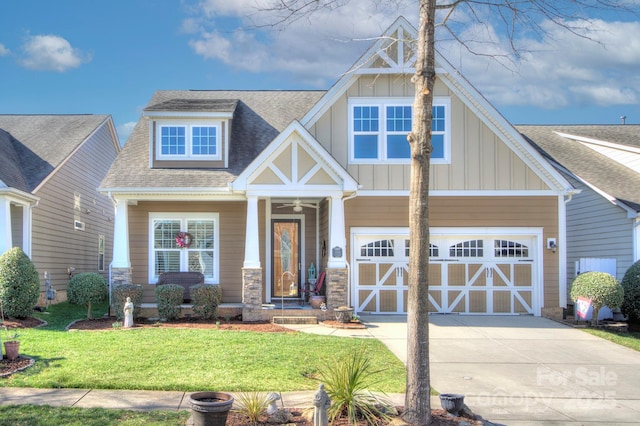 craftsman house with a front yard and a garage