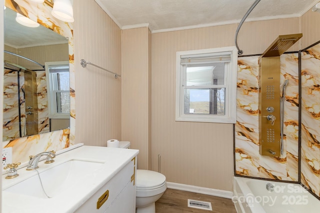 bathroom with toilet, visible vents, wood finished floors, and ornamental molding