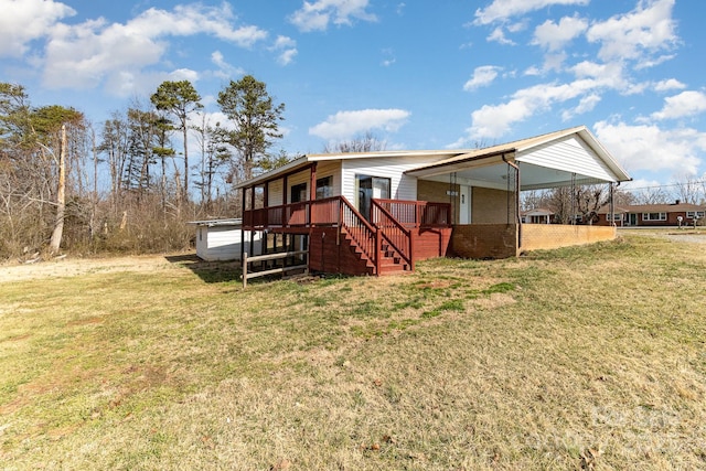 exterior space featuring stairway, a front yard, and a carport