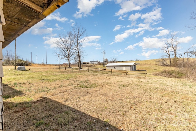 view of yard with a rural view and fence