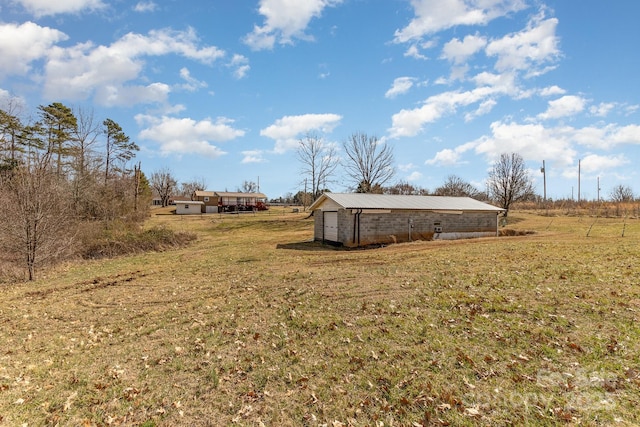 view of yard featuring an outbuilding and a rural view