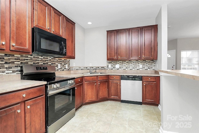 kitchen featuring sink, decorative backsplash, stainless steel appliances, and light tile patterned floors