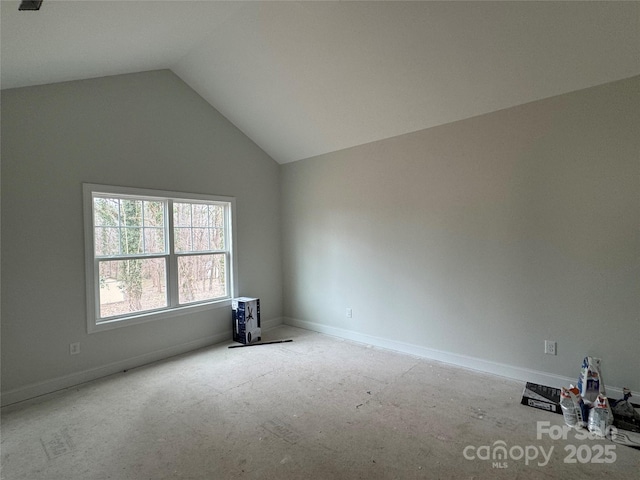 empty room featuring lofted ceiling