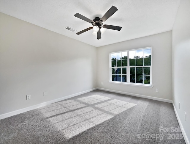 carpeted empty room featuring ceiling fan