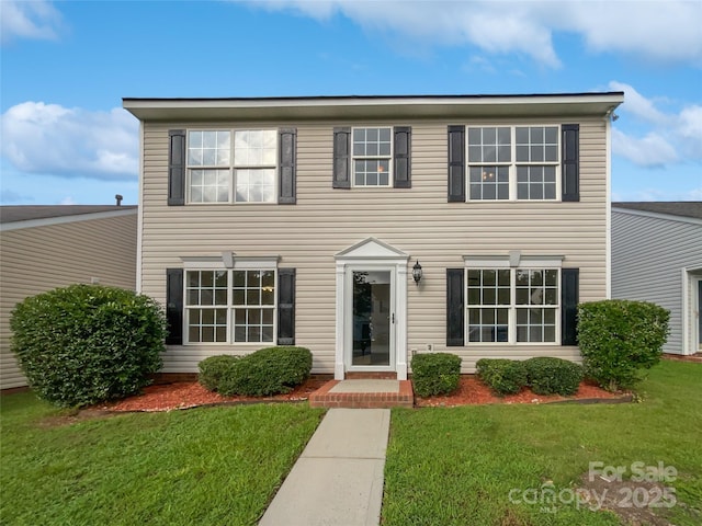 colonial inspired home with a front yard