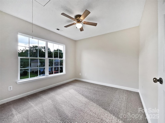 empty room with ceiling fan and carpet