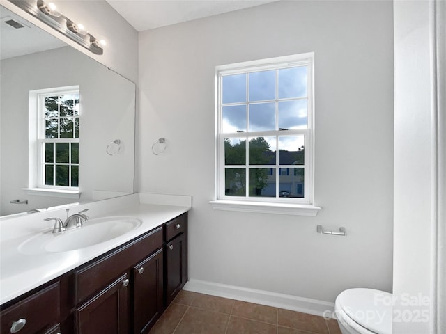 bathroom featuring vanity, toilet, and tile patterned flooring