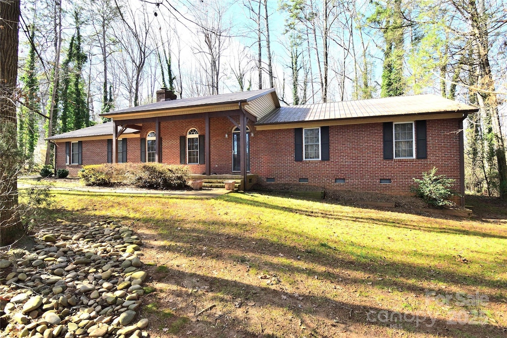 ranch-style house with a porch and a front yard