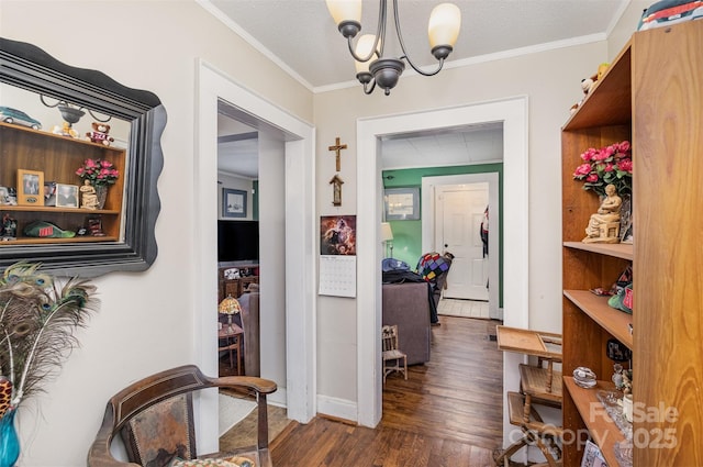 hall featuring crown molding, dark hardwood / wood-style floors, an inviting chandelier, and a textured ceiling