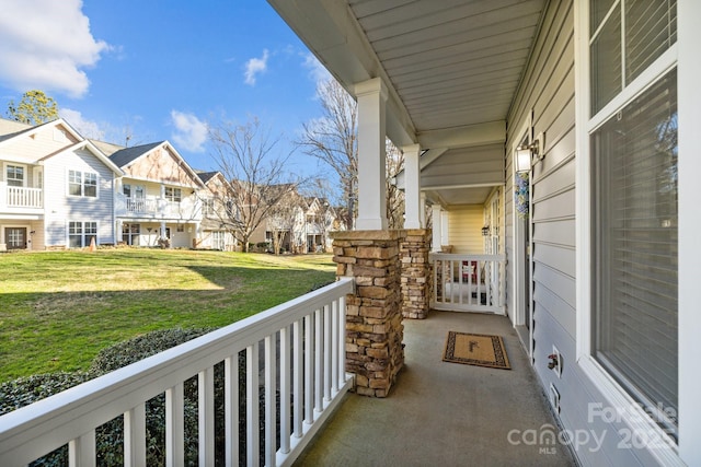 balcony featuring a porch and a residential view