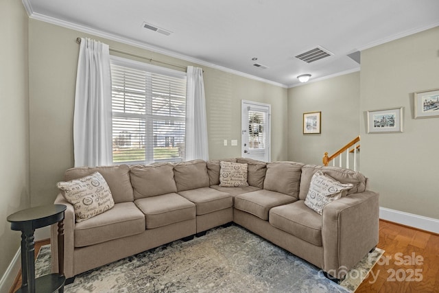 living area featuring ornamental molding, visible vents, and wood finished floors