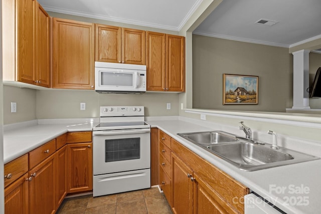 kitchen featuring light countertops, white appliances, a sink, and visible vents