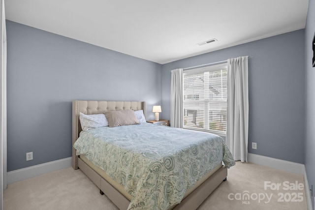 bedroom featuring light colored carpet, visible vents, and baseboards