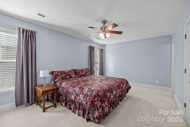 bedroom with baseboards, visible vents, and light colored carpet