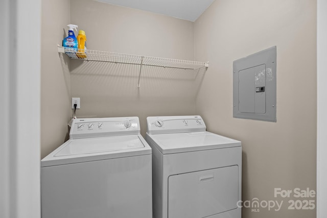 laundry area with washing machine and dryer, laundry area, and electric panel