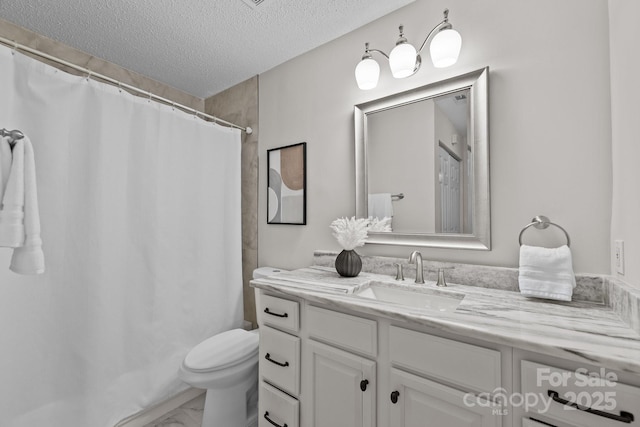 bathroom featuring a shower with curtain, vanity, toilet, and a textured ceiling