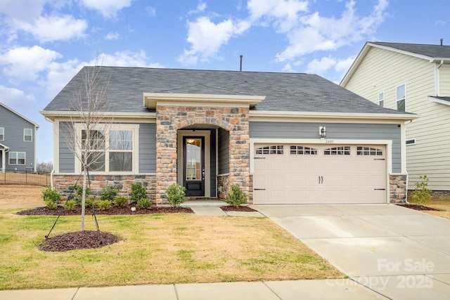 view of front of home featuring a garage and a front yard