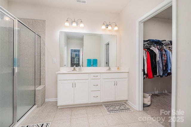 bathroom with vanity, tile patterned floors, and walk in shower