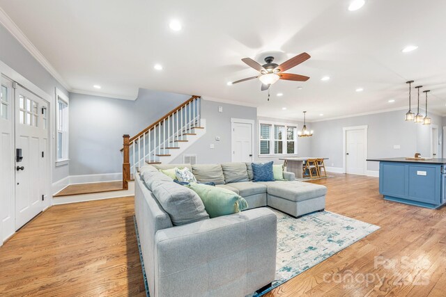 living room with light hardwood / wood-style flooring and ornamental molding