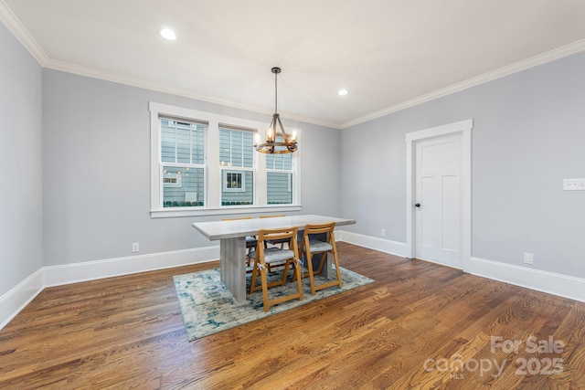 dining area with crown molding, dark wood-type flooring, and a chandelier