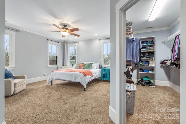 carpeted bedroom with crown molding and ceiling fan