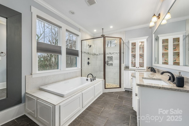 bathroom with ornamental molding, vanity, and shower with separate bathtub