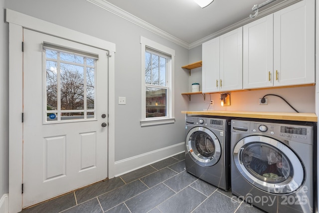 laundry room with cabinets, crown molding, a wealth of natural light, and washer and clothes dryer