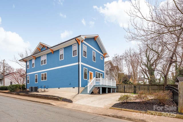 view of side of property featuring central air condition unit and a deck