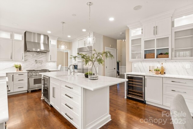 409 Running Horse Ln, Waxhaw, NC 28173 - kitchen with wall chimney exhaust hood, wine cooler, a sink, premium appliances, and decorative backsplash