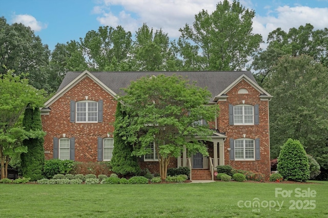 409 Running Horse Ln, Waxhaw, NC 28173 - view of front facade featuring brick siding and a front lawn