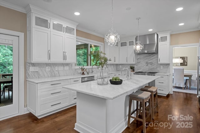 409 Running Horse Ln, Waxhaw, NC 28173 - kitchen featuring wall chimney range hood, a chandelier, white cabinets, dark wood finished floors, and tasteful backsplash