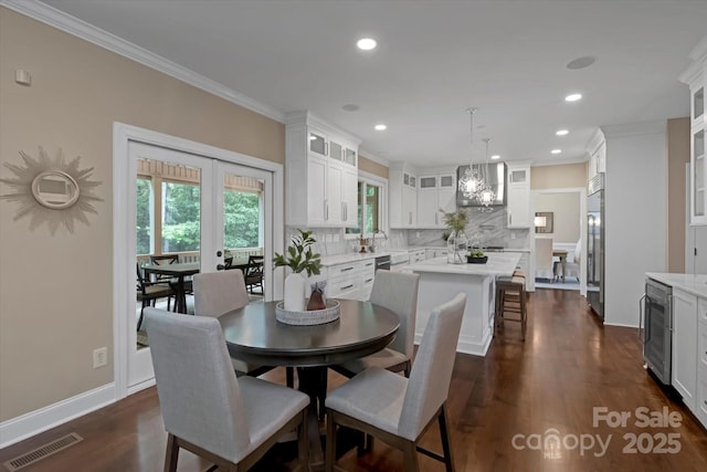 409 Running Horse Ln, Waxhaw, NC 28173 - dining space with beverage cooler, crown molding, dark wood-style flooring, baseboards, and recessed lighting