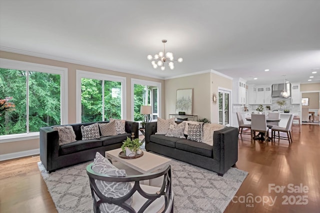 409 Running Horse Ln, Waxhaw, NC 28173 - living room with a chandelier, healthy amount of natural light, crown molding, wood finished floors, and recessed lighting