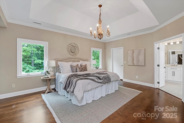 409 Running Horse Ln, Waxhaw, NC 28173 - bedroom featuring a tray ceiling, a chandelier, dark wood-style floors, baseboards, and ornamental molding