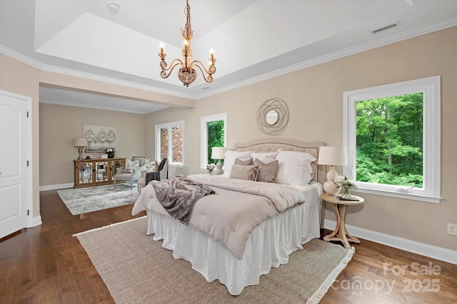 409 Running Horse Ln, Waxhaw, NC 28173 - bedroom featuring a chandelier, crown molding, baseboards, and wood finished floors