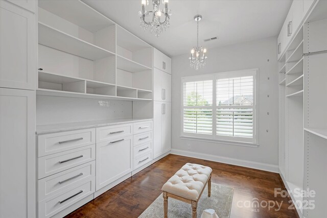 409 Running Horse Ln, Waxhaw, NC 28173 - spacious closet featuring a chandelier and dark wood finished floors