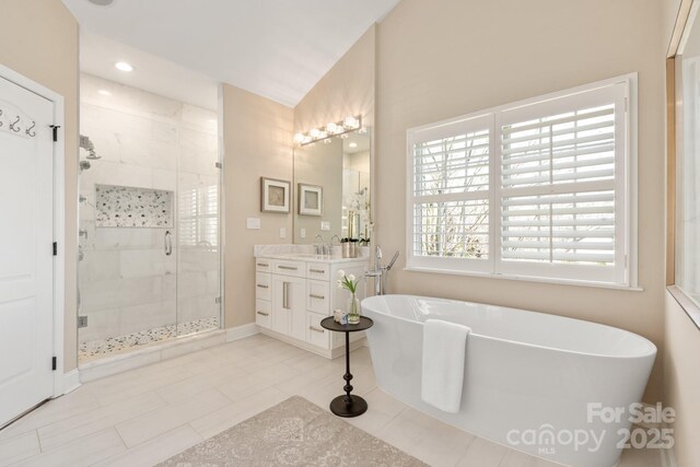 409 Running Horse Ln, Waxhaw, NC 28173 - full bath with a shower stall, vanity, a soaking tub, recessed lighting, and baseboards