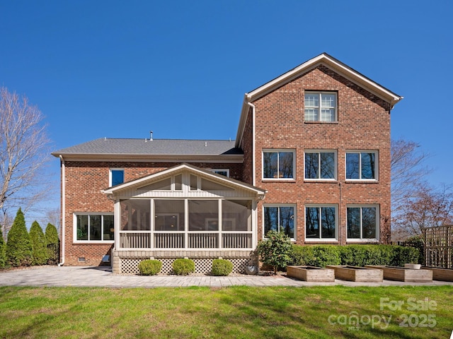 409 Running Horse Ln, Waxhaw, NC 28173 - rear view of house with brick siding, a sunroom, a yard, and a patio
