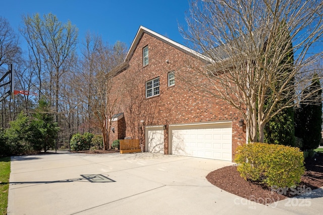 409 Running Horse Ln, Waxhaw, NC 28173 - view of side of home featuring brick siding, driveway, and a garage