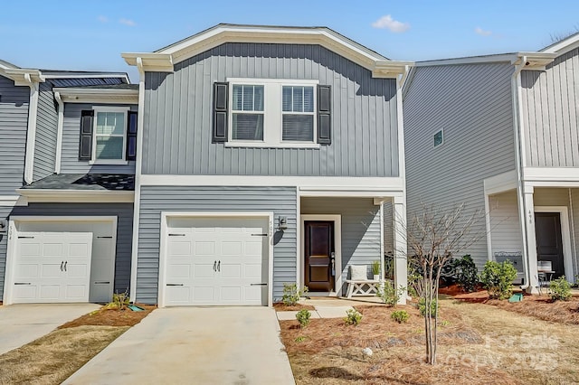 multi unit property featuring a garage, concrete driveway, a porch, and board and batten siding