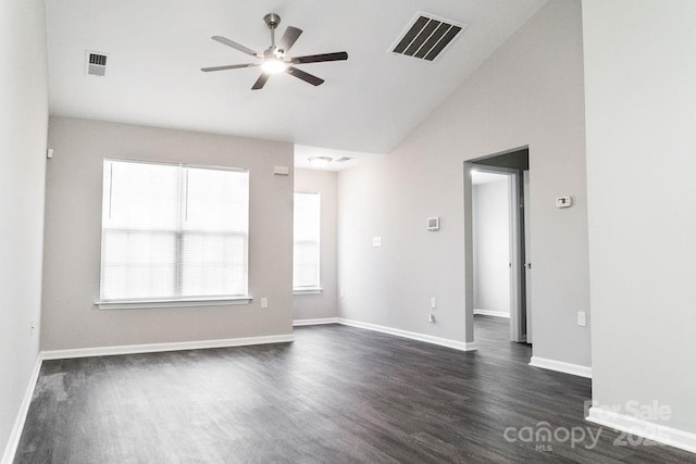 unfurnished room featuring lofted ceiling, visible vents, and plenty of natural light