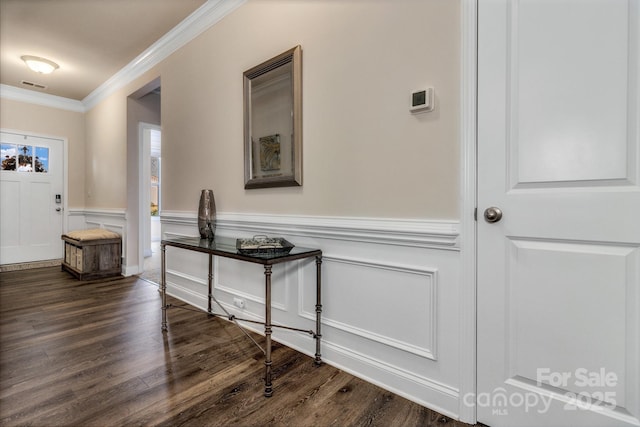 foyer with crown molding and dark wood-type flooring