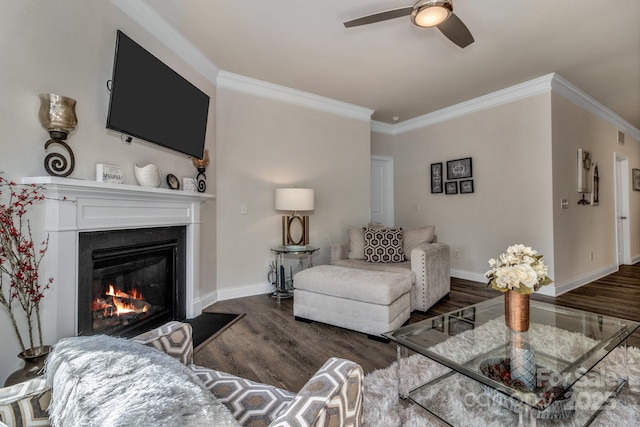 living room with ceiling fan, ornamental molding, and dark hardwood / wood-style flooring