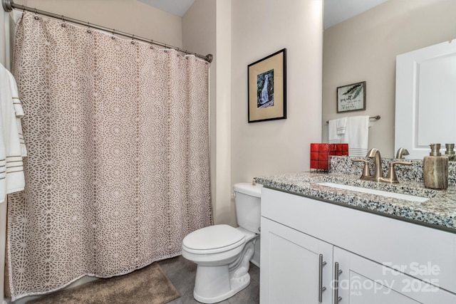 bathroom featuring tile patterned flooring, vanity, and toilet