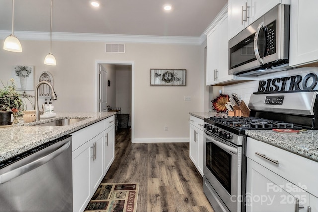 kitchen with sink, stainless steel appliances, white cabinets, and light stone countertops