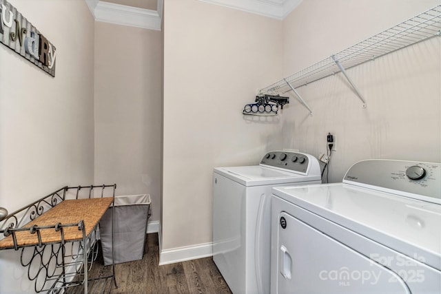 washroom featuring crown molding, dark hardwood / wood-style floors, and washer and dryer