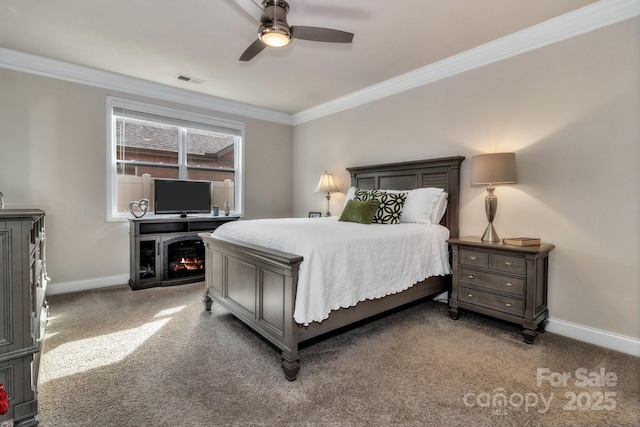 carpeted bedroom with ornamental molding and ceiling fan